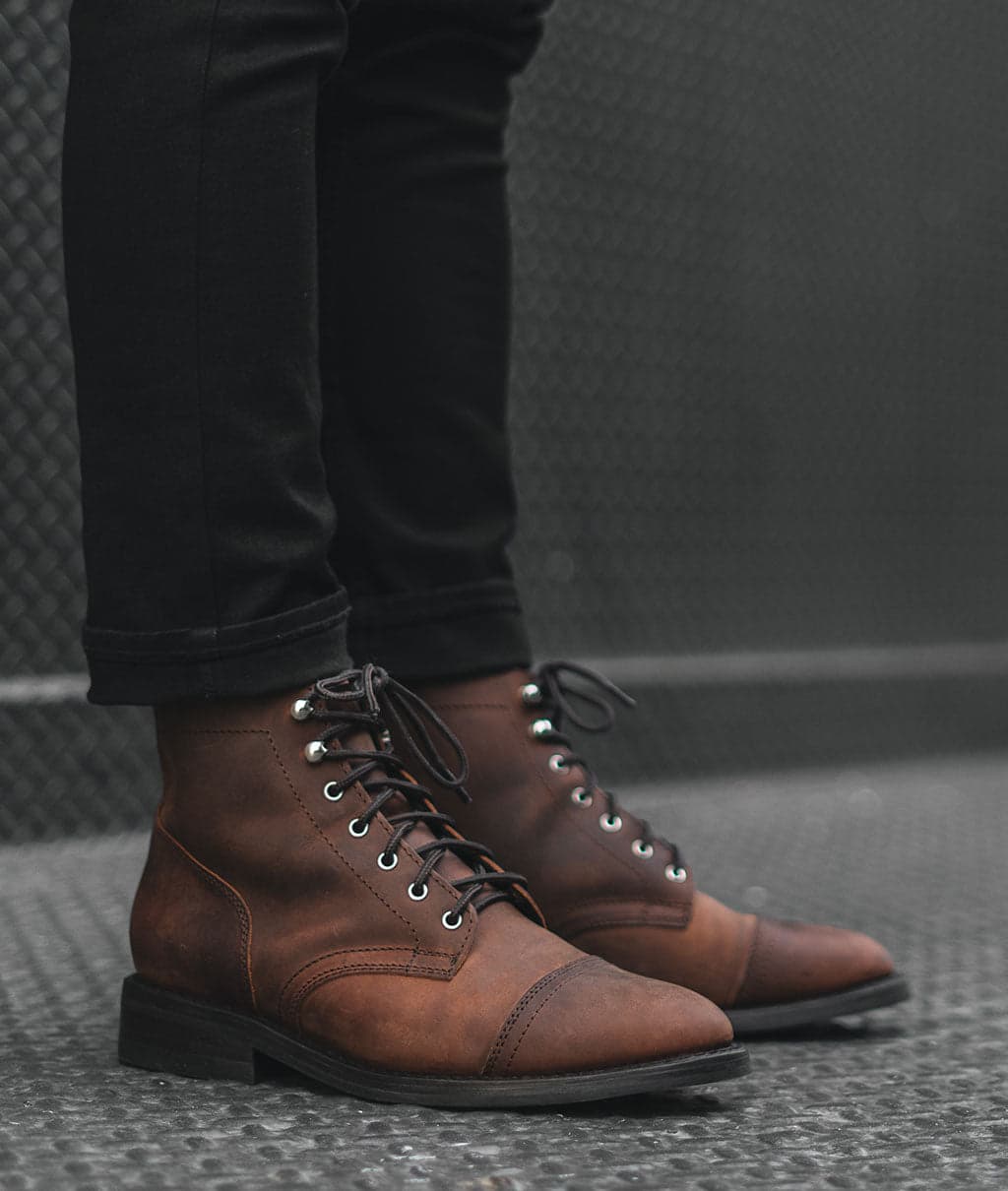 Brown lace-up boots on a rocky trail
