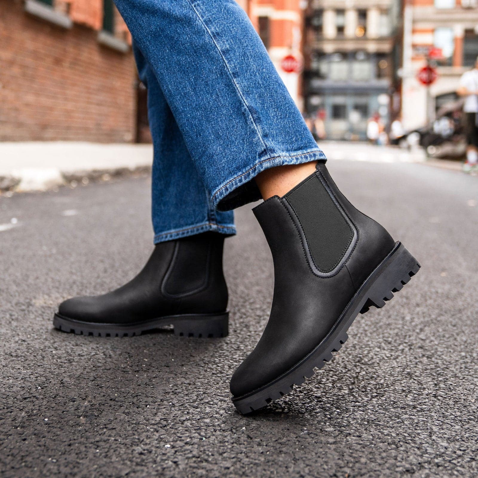Black Chelsea boots on a city street