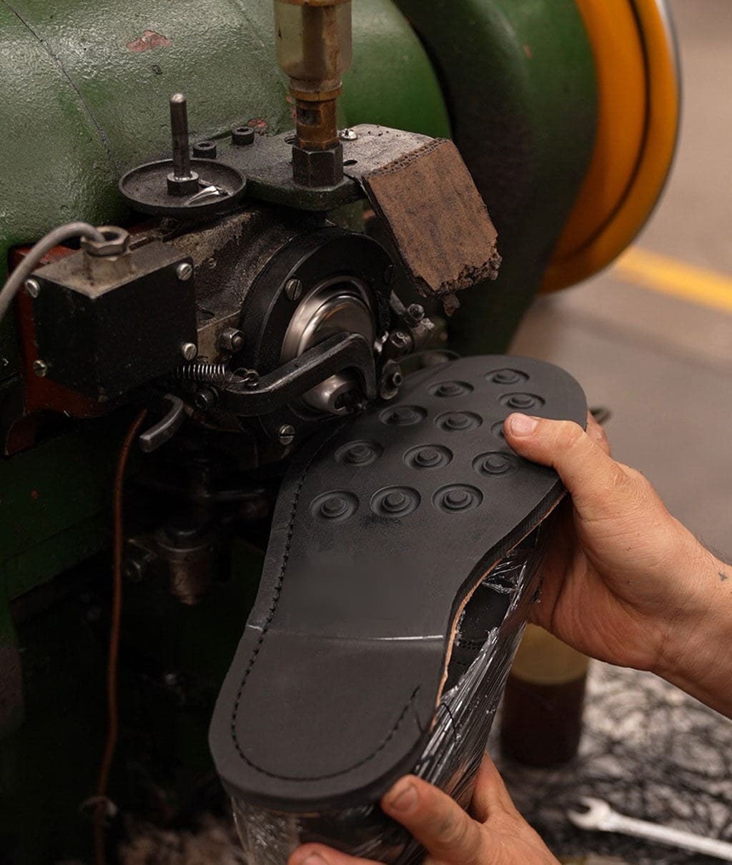A boot sole being pressed in the workshop